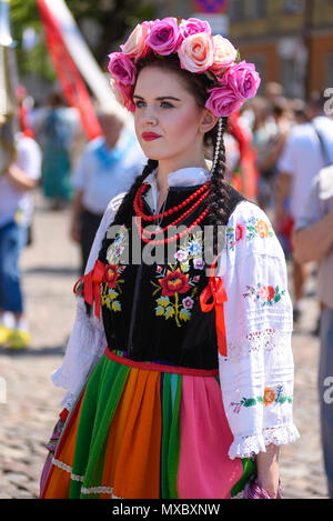 Lowicz / Poland - May 31.2018: Portrait of a woman dressed in a colorful folklore, regional costume with flower wreath on the head during Corpus Chris Stock Photo