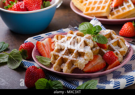Waffles with berries, strawberries, chocolate on top and mint Stock Photo