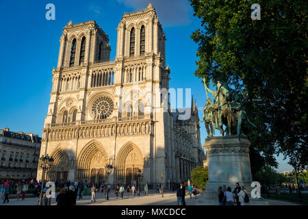 Evening sunlight on the Charlemagne statue and the front facade of Cathedral Notre Dame, Paris France Stock Photo