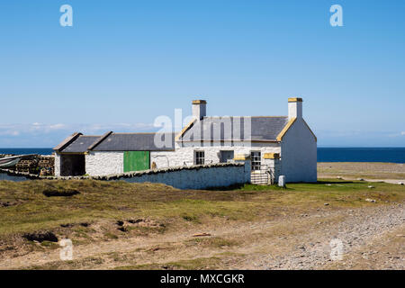 The old lighthouse keeper's cottage by beach on northern coast. Point of Ayre, Ramsey, Isle of Man, British Isles Stock Photo
