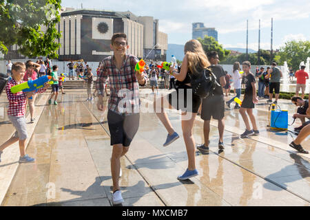 Sofia, Bulgaria - 8 July 2017: Children and adults participate in a fight with water guns and other water spray equipment in the center of Sofia. Stock Photo