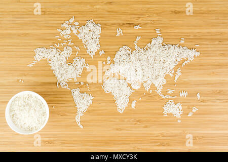 map of the world made of white rice on bamboo wood background with two ...
