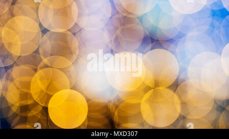 beautiful bokeh made of warm orange blurred lights on blue background, special photo technique Stock Photo