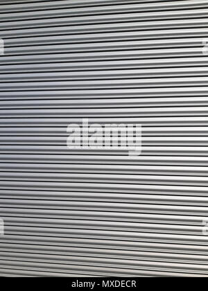 Old metal blinds painted with thick layer of light paint as background Aluminum blinds background. Stock Photo