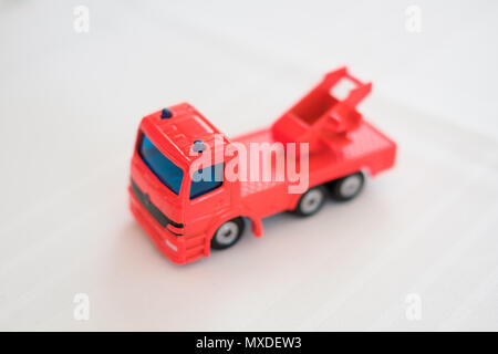 red toy car on white background , red toy truck model or firefighter Stock Photo