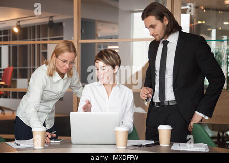 Business partners negotiating about strategies using laptop Stock Photo