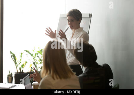 Businesswoman presenting company strategy on flipchart Stock Photo