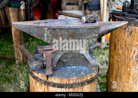 Anvil with two forging hammers in an outdoor forge Stock Photo