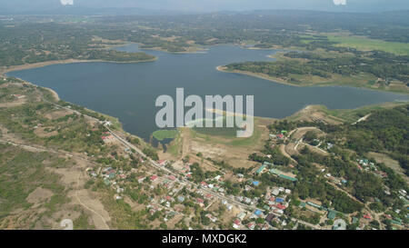 Aerial view of Paoay lake against background of mountains and sky with clouds. Paoay Lake National Park, Ilocos Norte, Philippines. Stock Photo