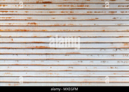 Old gray rusted corrugated metal wall, frontal background photo texture Stock Photo