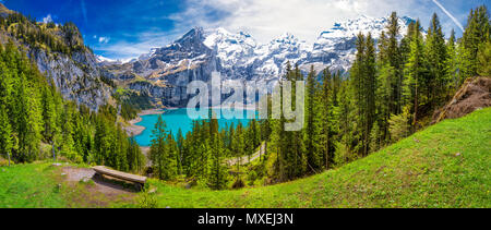 Amazing tourquise Oeschinnensee with waterfalls, wooden chalet and Swiss Alps, Berner Oberland, Switzerland.