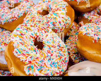 super size Iced donuts with sprinkles Stock Photo