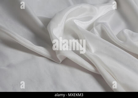 Closeup of rippled white silk fabric background Stock Photo