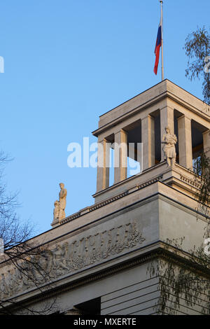 Berlin, Germany - April 14, 2018: Top of Russian Federation Embassy building with flag, statues and USSR coat of arms Stock Photo