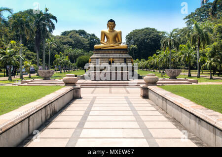 The golden buddha statue in the Viharamahadevi park in the center of Colombo, the capital of Sri Lanka Stock Photo