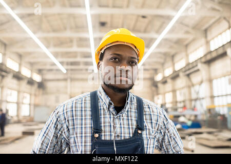 Machine Operator Listening to Music in Headphones Stock Photo