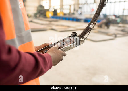 Machine Operator Using Control Panel Stock Photo