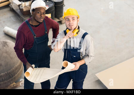 Young Technicians Wrapped up in Discussion Stock Photo
