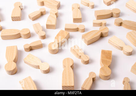 Wooden figures of people are lying on a white background. The concept of human resources management. Headhunters. Search for people to work. The searc Stock Photo