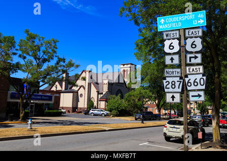 Wellsboro, PA, USA - July 26, 2016: Directional Route Signs on the Main Street of Wellsboro in Tioga County, Pennsylvania Stock Photo