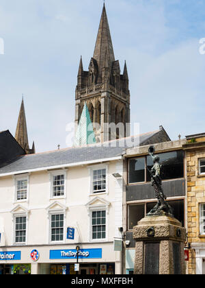 The main and secondary spires of Truro Cathedral dominate the skyline above the war memorial in Boscowan street, Truro, Cornwall, UK Stock Photo