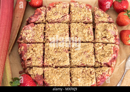 Freshly baked strawberry and rhubarb crumble slice. Gluten and dairy free. A healthy dessert or snack. Stock Photo