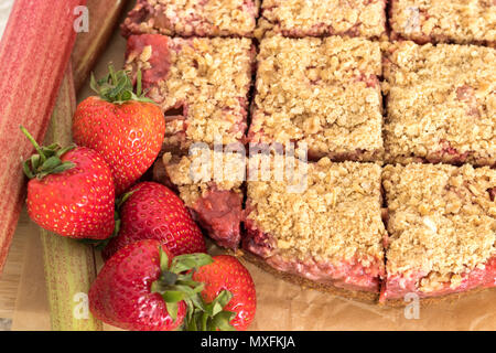 Freshly baked strawberry and rhubarb crumble slice. Gluten and dairy free. A healthy dessert or snack. Stock Photo