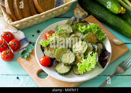 Fried zucchini or cucumber. Fast food on the kitchen table. Stock Photo