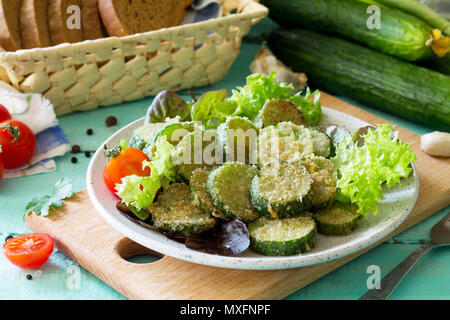 Fried zucchini or cucumber. Fast food on the kitchen table. Stock Photo