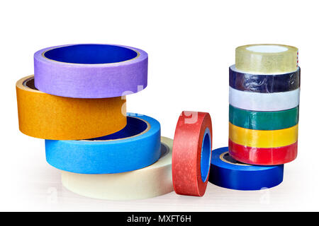 Several rolls of masking tape and stack of electrical tape isolated on white background with saved clipping path. Stock Photo