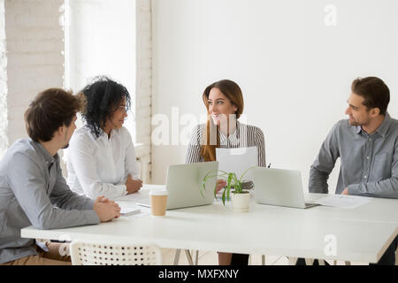 Multiracial team discussing work contract in coworking space Stock Photo