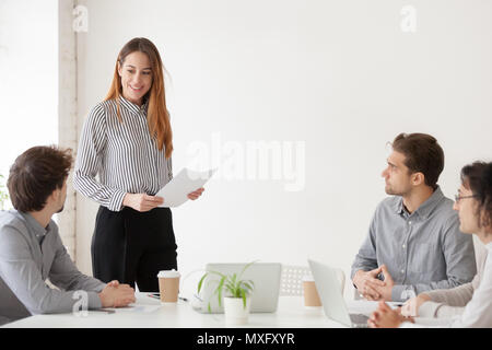 Female team leader presenting new project to colleagues at meeti Stock Photo