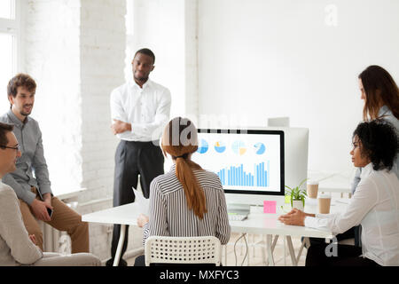 Female team leader talking to colleagues about new project Stock Photo