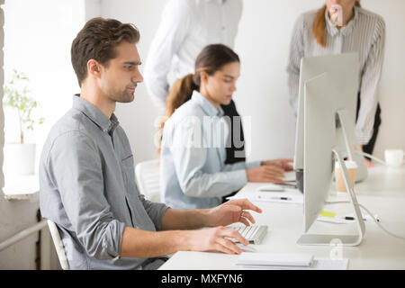 Focused male worker reading business news online Stock Photo