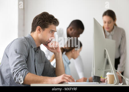 Thoughtful employee surfing web reading financial news Stock Photo