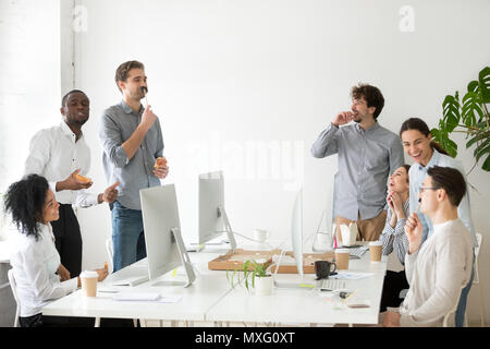 Friendly diverse team having fun during lunch break Stock Photo