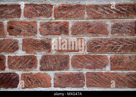 A close-up of a classic red brick wall with visible textures and mortar lines, showing the natural wear and distinct patterns of each brick, Stock Photo