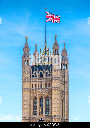 The Union Flag flies high over the houses of parliament at westminster Stock Photo