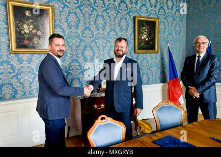The National Film Archive (NFA) and the Film and Television School of the Academy of Performing Art (FAMU) in Prague made an agreement on the digitisation of Czech films today, on Monday, June 4, 2018. The agreement, signed by FAMU Dean Zdenek Holy, left, and NFA director Michal Bregant, guarantees that the digital restoration would be carried out in cooperation with the living film-makers, primarily the director, photographer and sound mixer, that their testimonies and expert opinions will be recorded. On the photo right there is Culture Minister Ilja Smid. (CTK Photo/Vit Simanek) Stock Photo