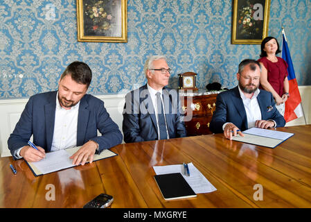The National Film Archive (NFA) and the Film and Television School of the Academy of Performing Art (FAMU) in Prague made an agreement on the digitisation of Czech films today, on Monday, June 4, 2018. The agreement, signed by FAMU Dean Zdenek Holy, left, and NFA director Michal Bregant, right, guarantees that the digital restoration would be carried out in cooperation with the living film-makers, primarily the director, photographer and sound mixer, that their testimonies and expert opinions will be recorded. On the photo centre there is Culture Minister Ilja Smid. (CTK Photo/Vit Simanek) Stock Photo