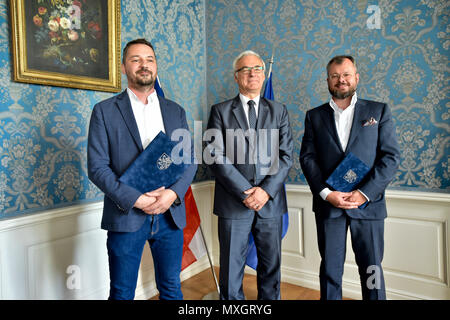 The National Film Archive (NFA) and the Film and Television School of the Academy of Performing Art (FAMU) in Prague made an agreement on the digitisation of Czech films today, on Monday, June 4, 2018. The agreement, signed by FAMU Dean Zdenek Holy, left, and NFA director Michal Bregant, right, guarantees that the digital restoration would be carried out in cooperation with the living film-makers, primarily the director, photographer and sound mixer, that their testimonies and expert opinions will be recorded. On the photo centre there is Culture Minister Ilja Smid. (CTK Photo/Vit Simanek) Stock Photo