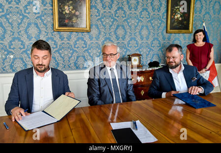 The National Film Archive (NFA) and the Film and Television School of the Academy of Performing Art (FAMU) in Prague made an agreement on the digitisation of Czech films today, on Monday, June 4, 2018. The agreement, signed by FAMU Dean Zdenek Holy, left, and NFA director Michal Bregant, right, guarantees that the digital restoration would be carried out in cooperation with the living film-makers, primarily the director, photographer and sound mixer, that their testimonies and expert opinions will be recorded. On the photo centre there is Culture Minister Ilja Smid. (CTK Photo/Vit Simanek) Stock Photo