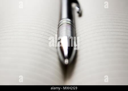 Pen laying over notebook Stock Photo
