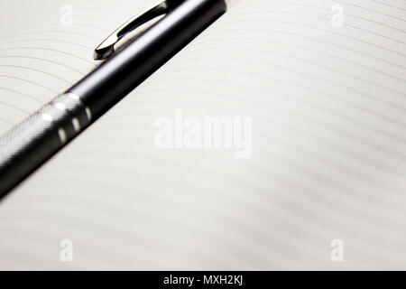 Pen laying over notebook Stock Photo
