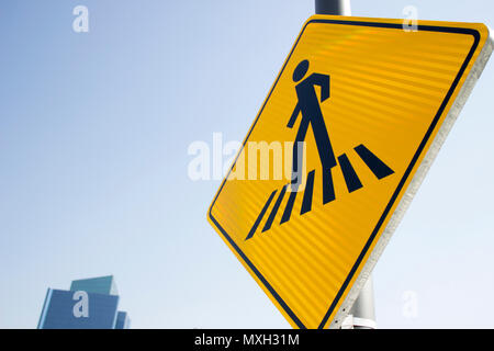 A pedestrian street sign and a building behind. Stock Photo