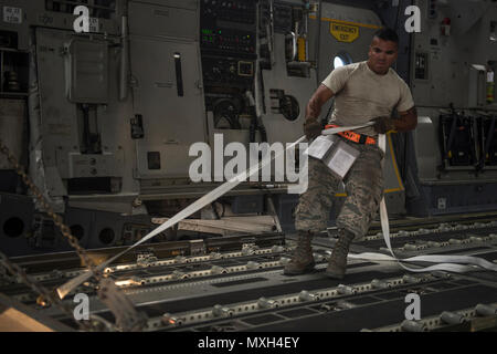 Senior Airman Zephaniah Valdez, 8th Expeditionary Air Mobility Squadron ramp transportation journeyman, pulls a pallet into an 816th Expeditionary Airlift Squadron C-17 Globemaster III in support of Operation Freedom’s Sentinel Nov. 3, 2016. The operation focuses on training, advising, and assisting the Afghan Security Institutions and Afghan National Defense and Security Forces in order to build their capabilities and long-term sustainability. (U.S. Air Force photo by Staff Sgt. Matthew B. Fredericks) Stock Photo