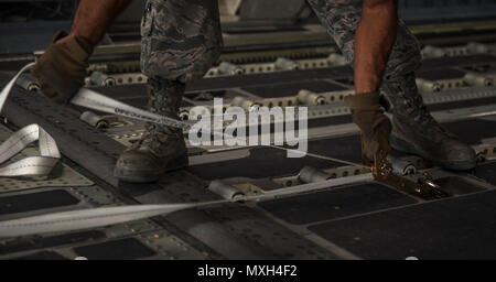 Senior Airman Zephaniah Valdez, 8th Expeditionary Air Mobility Squadron ramp transportation journeyman, prepares to pull a pallet into an 816th Expeditionary Airlift Squadron C-17 Globemaster III in support of Operation Freedom’s Sentinel Nov. 3, 2016. The operation focuses on training, advising, and assisting the Afghan Security Institutions and Afghan National Defense and Security Forces in order to build their capabilities and long-term sustainability. (U.S. Air Force photo by Staff Sgt. Matthew B. Fredericks) Stock Photo