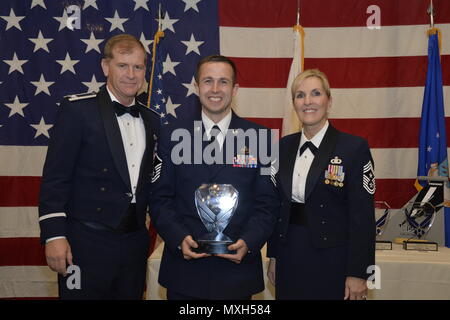 U.S. Air Force Col. Reed Drake, 144th Fighter Wing Commander and Chief Master Sgt. Linda Brown, 144th Fighter Wing Command Chief, present Master Sgt. Ryan Hansen, 144th Operations Group, with his plaque for being selected as the Senior Non-commissioned Officer category 144th Fighter Wing Airman of the Year, November 5, 2016. (Air National Guard photo by Tech. Sgt. Charles Vaughn) Stock Photo
