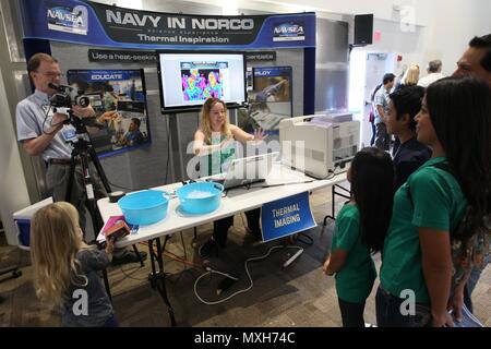 161105-N-HW977-115  NORCO, Calif. (Nov. 5, 2016) Kevin Janosky, left, and Amanda Lynch make a thermal imaging portrait of a family with a forward-looking infrared (FLIR) camera during the Open House Science Experience at Naval Surface Warfare Center (NSWC), Corona Division. The event included numerous hands-on exhibits of Navy-relevant science, technology, engineering and math for local K-12 students, as well as laboratory tours and historic displays showcasing the command's 75-year presence in the Inland Empire. (U.S. Navy photo by Greg Vojtko/Released) Stock Photo