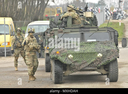 U.S. Army 1st Lt. Alexander G. Canacci, Paratrooper, Company D, 2nd Battalion, 503rd Infantry Regiment, 173rd Airborne Brigade, directs traffic during a Polish Independence Day parade involving his unit, Canadian soldiers assigned to 1st Battalion, Princess Patricia Canadian Light Infantry, and Polish soldiers (not pictured) throughout the township of Drawsko Pomorskie, Poland, Nov. 11, 2016. The Troops helped their Polish counterparts celebrate the country's national holiday that commemorates the anniversary of the restoration of Poland's sovereignty as the Second Polish Republic in 1918. (U. Stock Photo